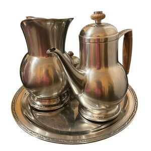 The tea set is a vintage Mid-Century Modern Oneida Custom Mediterranea Elegant